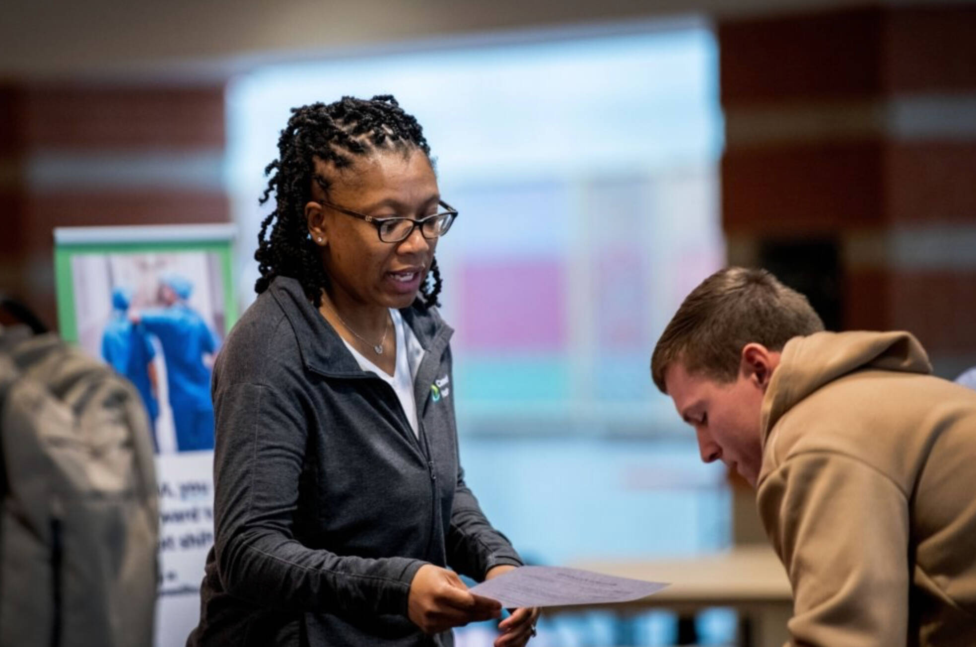 Employer reading a paper to a student.